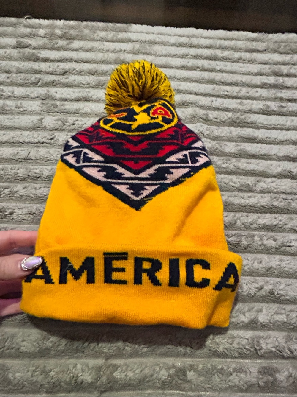 Yellow Pom Pom Beanie with 'AMERICA' Knit